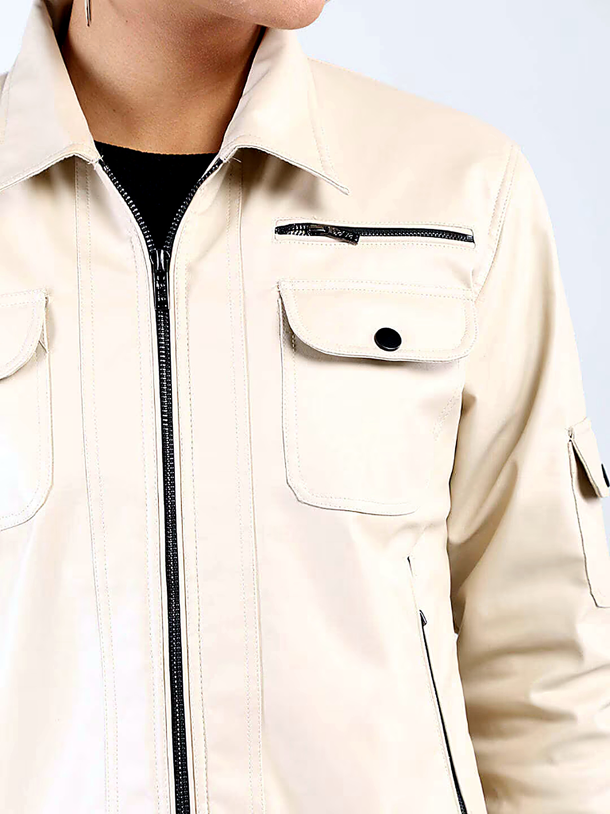 Technical utility outerwear jacket detailing contrast zippers, flap cargo pockets, and precision seams